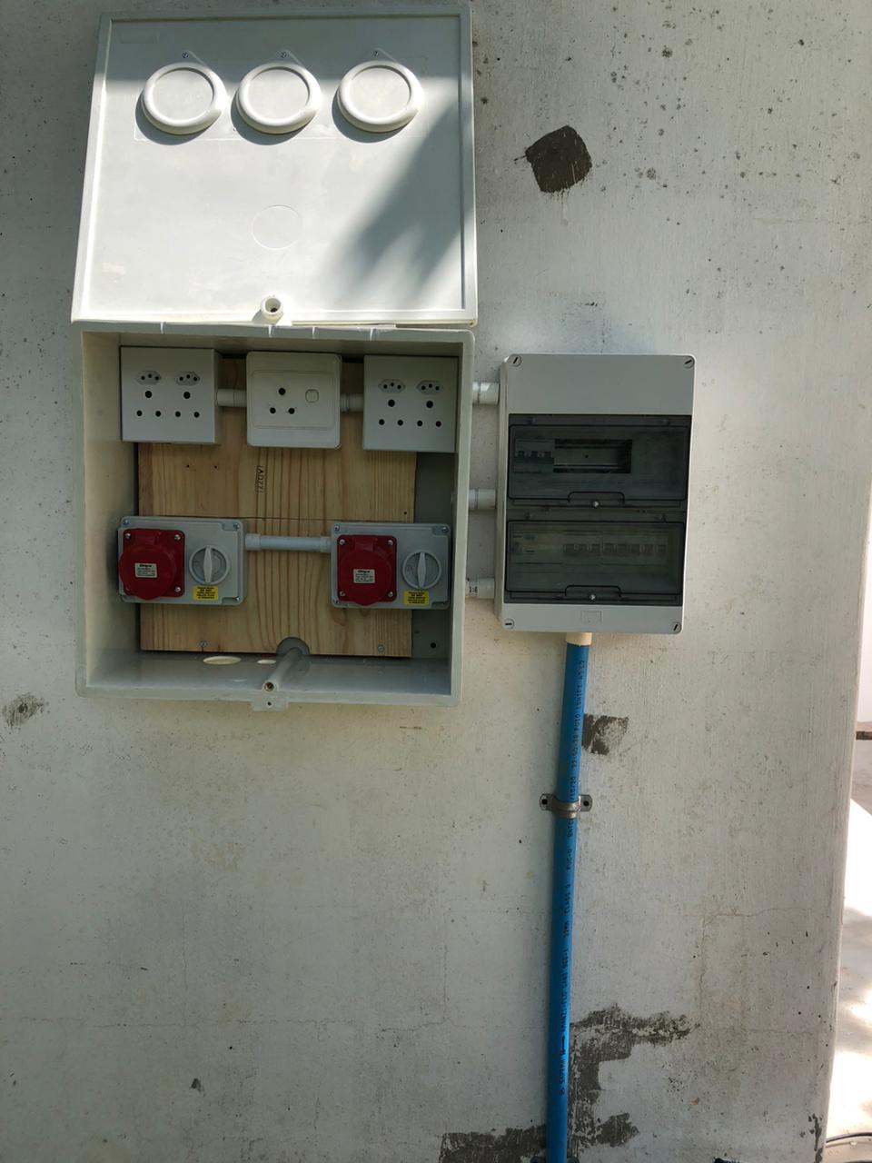 Industrial outlet board with three-phase red sockets and isolators